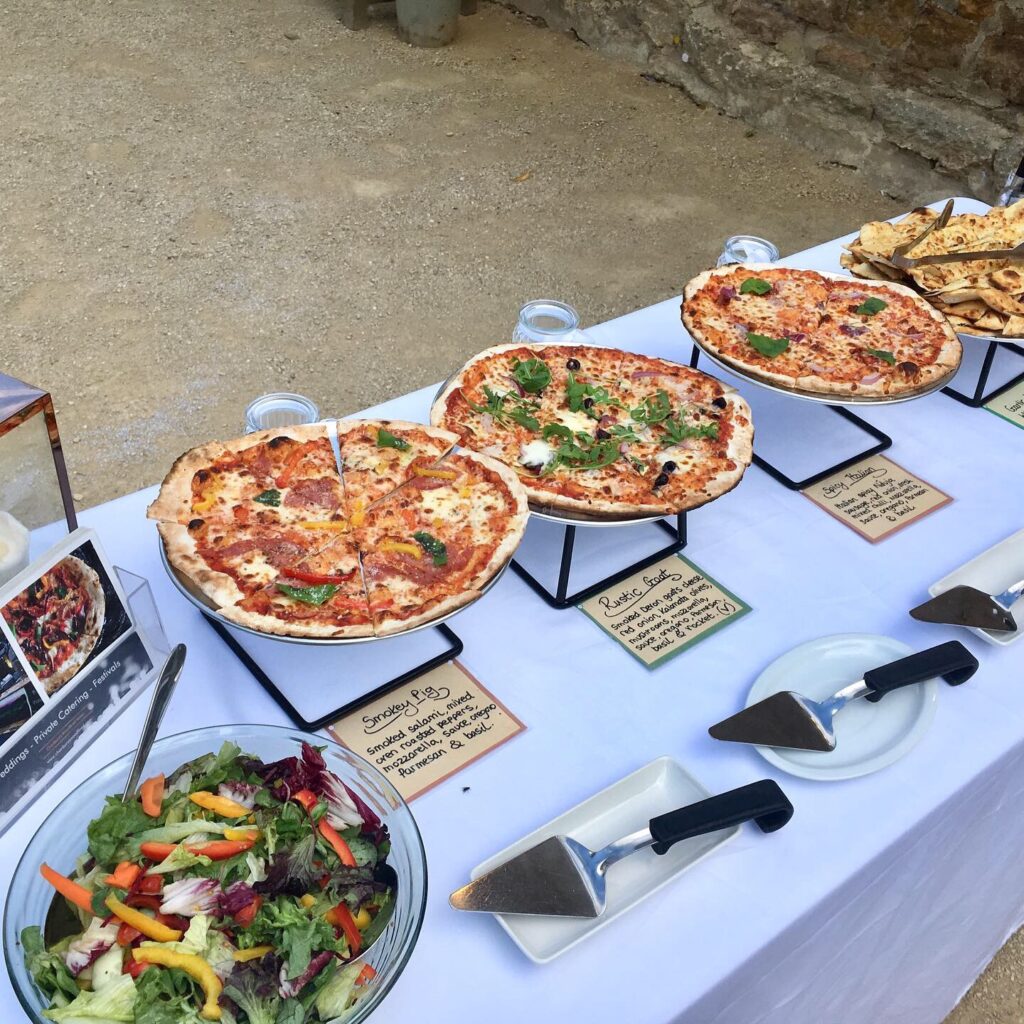 Woodfired pizza buffet service with side salad and cheesy garlic bread.